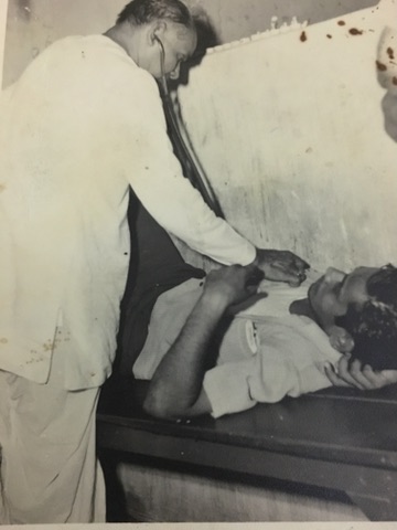 Dr. A. K. Das examining a patient